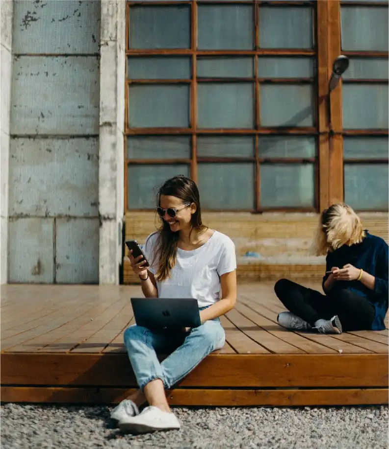 a teenager sitting and shooting video on her phone