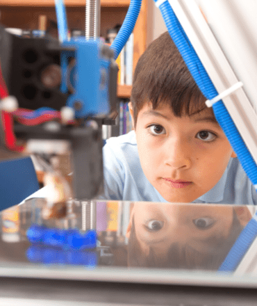image of a boy printing a 3d object on a 3d printer