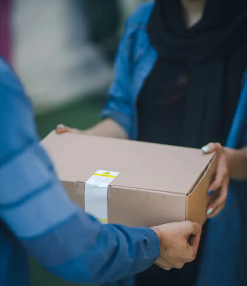 delivery person handing a package to the buyer which he has ordered online